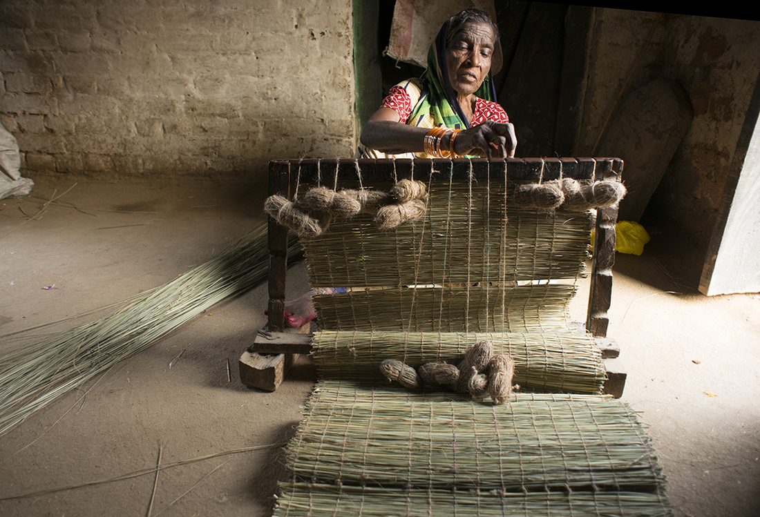 a weaver making a mat